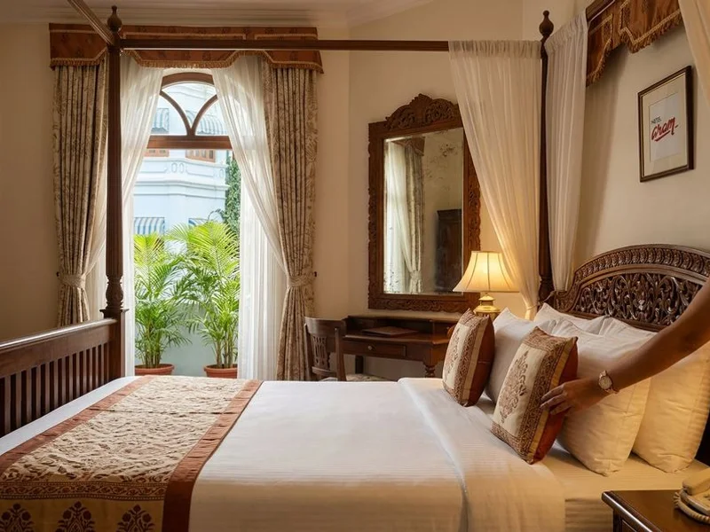 Deluxe heritage room with original Burmese wood carvings at Hotel Aram