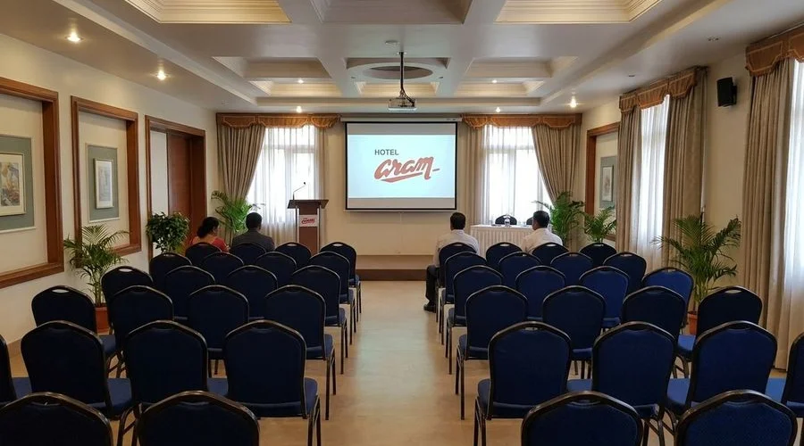 Conference hall in theatre-style setup with screen and professional AV equipment