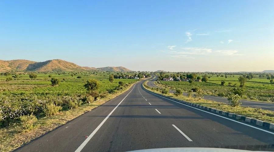 Scenic highway through the Saurashtra countryside with rolling green hills
