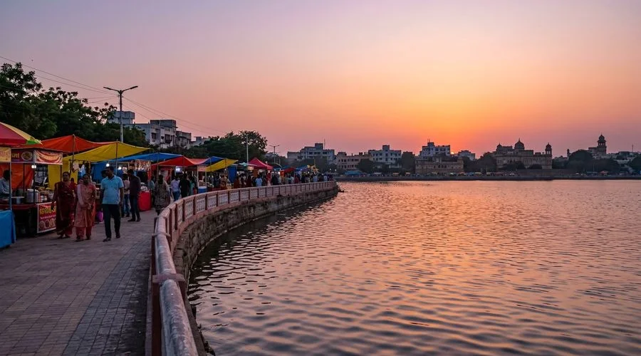 Sunset view over Lakhota Lake with the evening market beginning in Jamnagar